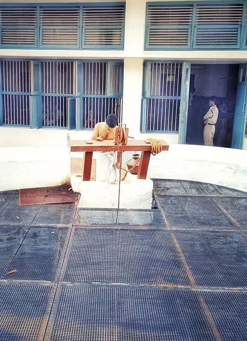 The Ashram priest Giridhar drawing water from the ashram well with a wooden pulley