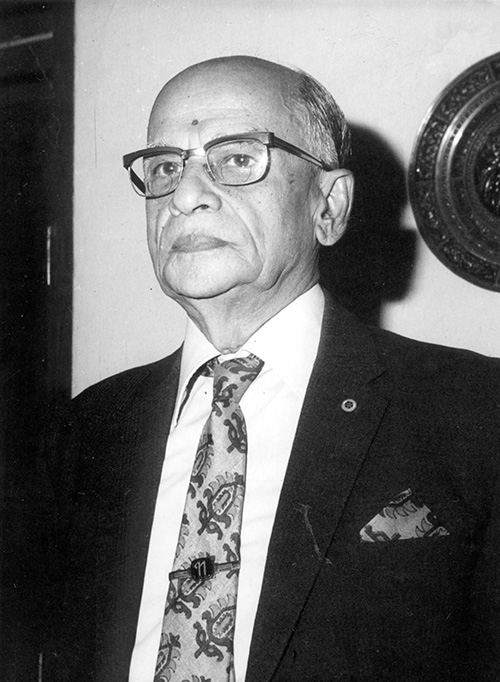 Black-and-white portrait of Sri K.K. Nambiar, engineer and devotee of Bhagavan Sri Ramana Maharshi, in suit and tie